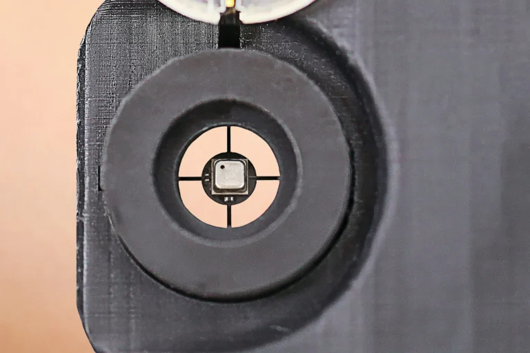 close-up-of-a-micro-sensor-situated-at-the-center-of-an-opening-shaped-like-a-circle-with-a-plus-sig.webp